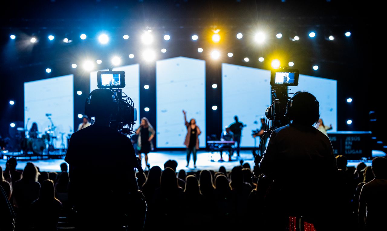 services-01 Energetic live concert scene with cameramen filming the vibrant stage performance.